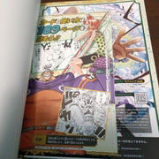 Comic book open to a page with anime-style illustration and text