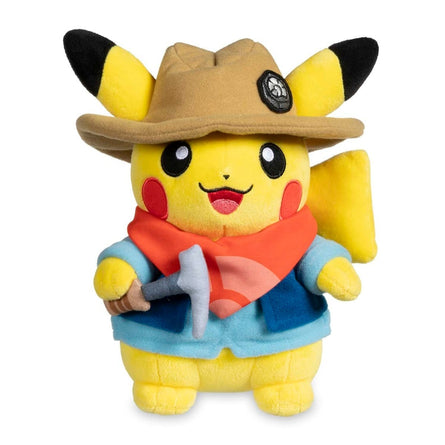 Plush toy of Pikachu wearing a hat and outfit on a white background