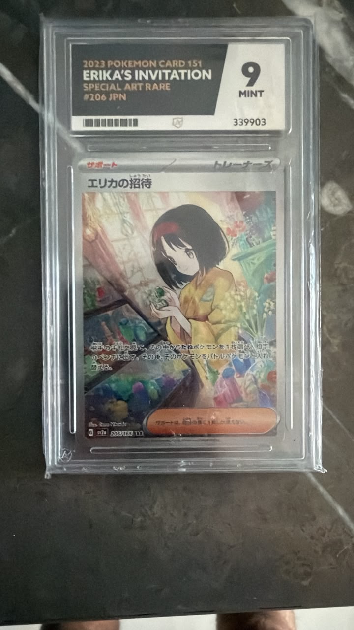 A graded Pokémon card, ERIKAS INVITATION #2304 IPN, sealed in a clear PSA grading slab with a 9 Mint grade label. The card features anime artwork of a girl in a kimono and is displayed on a dark marble surface.