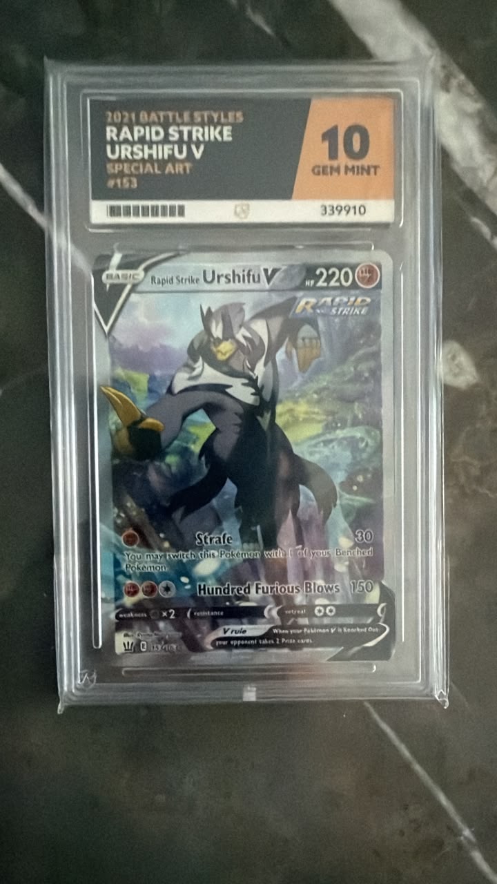 A graded Pokémon TCG card, Urshifu V from the 2024 Battle Styles set, sealed in a clear PSA 10 Gem Mint slab. The card is graded 10 for quality and is displayed on a dark marble surface.