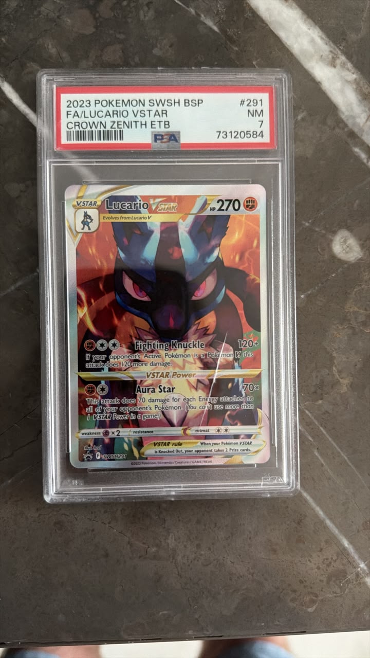 A graded Pokémon Swish BSP Falucario Vstar trading card in a clear PSA slab, photographed on a dark stone surface. The slab label shows PSA branding and the card art features a fiery dragon-like character.