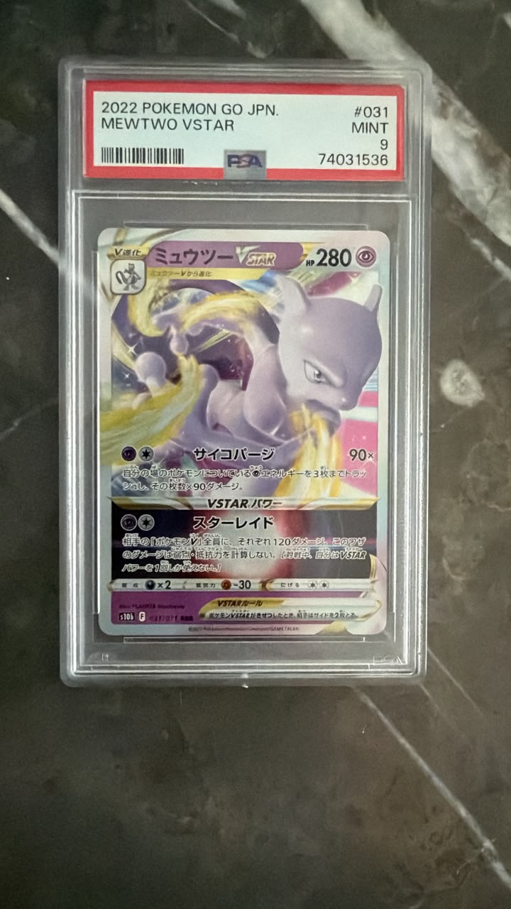 A graded 2022 Pokémon GO JPN Mewtwo V-Star trading card, PSA 9 Mint, sealed in a clear plastic PSA holder and placed on a dark marble surface.